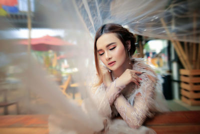 Portrait of young woman looking at camera