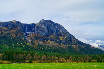 Waterfall, mountain, greenery and even snow-capped peaks 