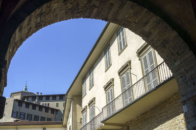 Low angle view of buildings against clear blue sky