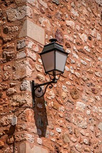 Low angle view of lamp mounted on wall