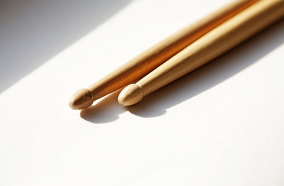 High angle view of cigarette on table against white background