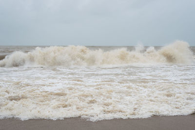 Waves breaking against sea