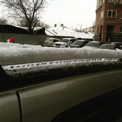 Snow covered road with trees in background