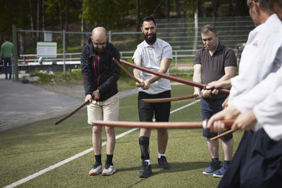 Men learning how to use katanas