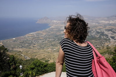 Rear view of woman looking at view from observation point at erice