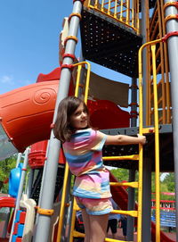 Side view of girl playing at playground