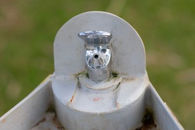 High angle view of old faucet on field