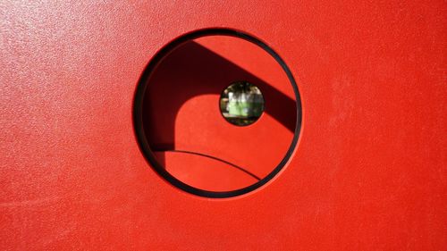 High angle view of sunglasses on table against red wall