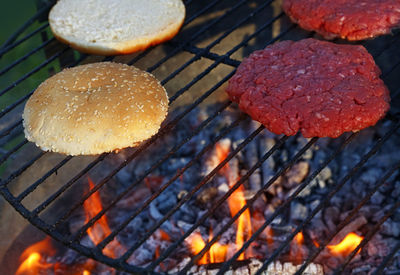 High angle view of bun with meat on barbecue grill