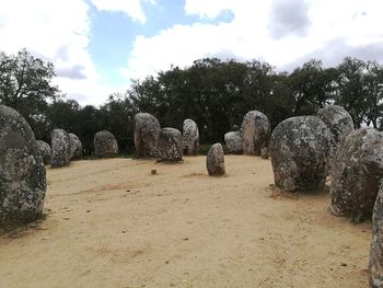Panoramic shot of rocks on field against sky
