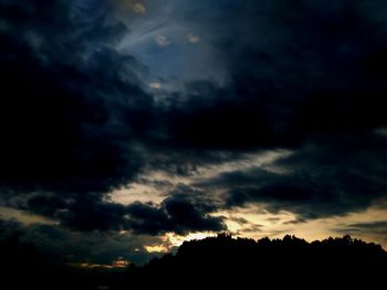 Silhouette of tree against cloudy sky