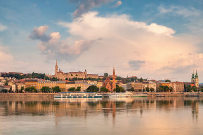 River by buildings against sky in city