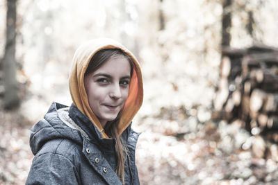 Portrait of smiling girl standing in forest