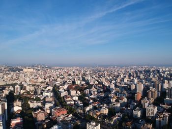 High angle view of buildings against blue sky