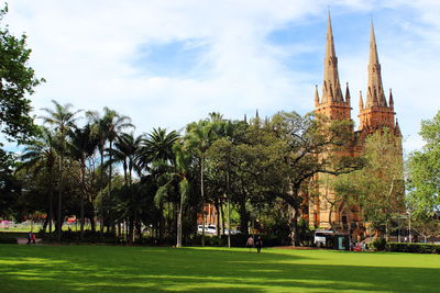 Trees in temple against building