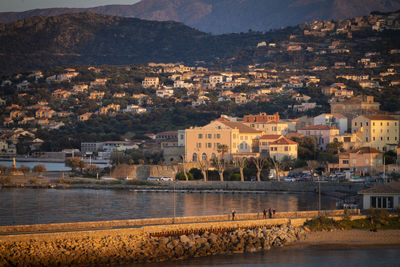 Town by river and buildings in city