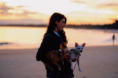Side view of woman with dog on beach