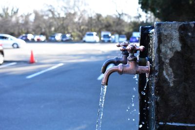 Close-up of faucet on road