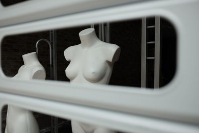 Mannequins seen through window