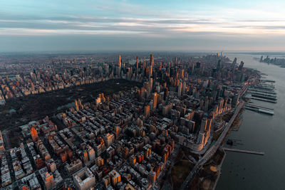 High angle view of buildings against cloudy sky