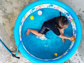 High angle view of boy playing in swimming pool