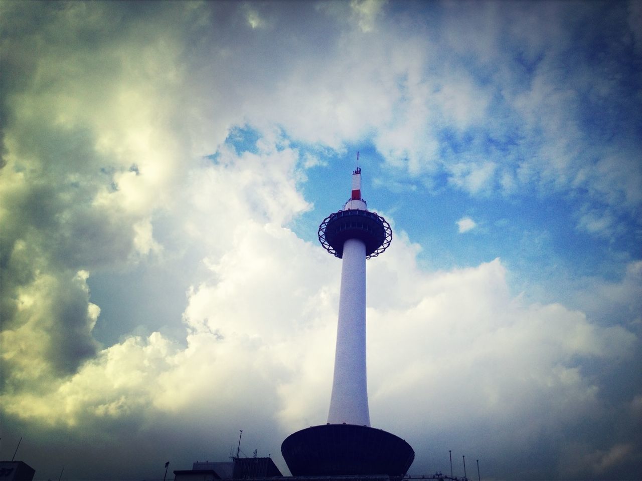 low angle view, sky, cloud - sky, tower, communications tower, tall - high, architecture, built structure, television tower, building exterior, communication, fernsehturm, sphere, culture, spire, cloudy, travel destinations, travel, cloud, famous place