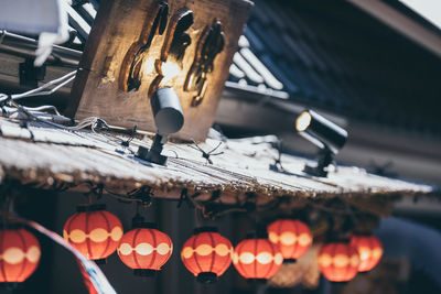 Low angle view of illuminated lanterns hanging in temple