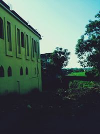 Exterior of abandoned house against clear sky