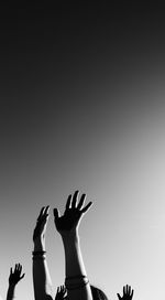 Low angle view of woman standing against clear sky