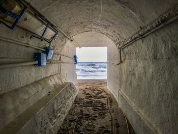 Scenic view of sea seen through tunnel