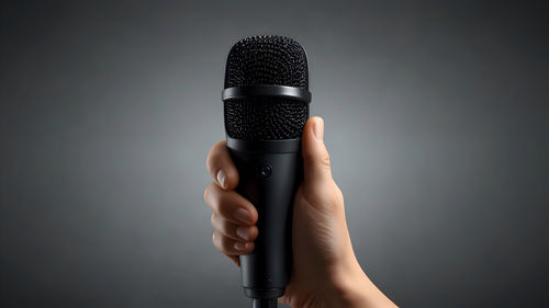 Close-up of microphone against black background