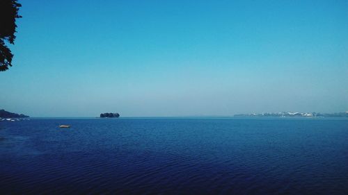 Scenic view of sea against clear blue sky