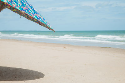 Close-up of beach against sky