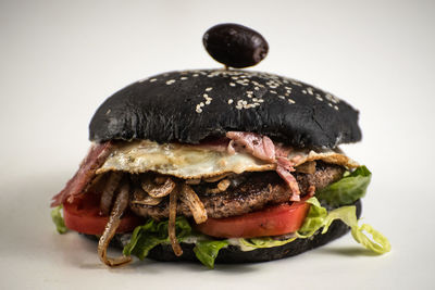 Close-up of burger against white background