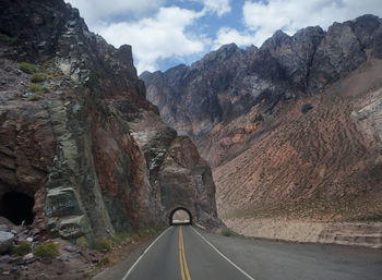 Road amidst mountains against sky