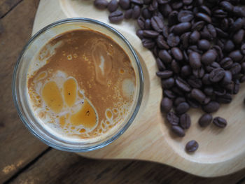 High angle view of coffee beans in glass on table