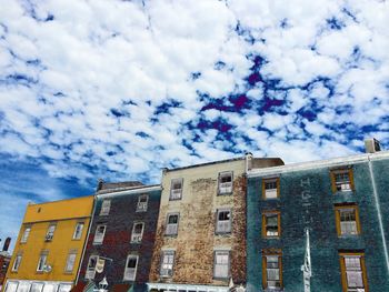 Low angle view of building against cloudy sky