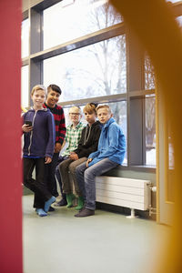 Full length portrait of school boys in corridor