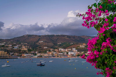 Scenic view of sea by mountains against sky