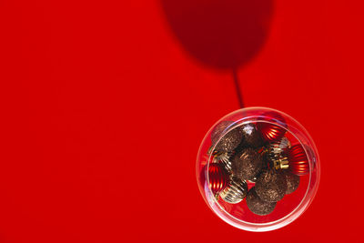 High angle view of glass against red background