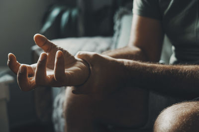 Midsection of man holding hands