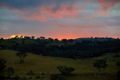 Scenic view of landscape against sky at sunset