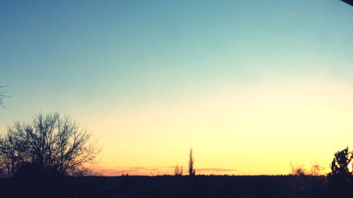 Silhouette landscape against clear sky during sunset