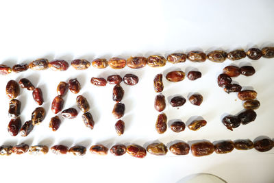 High angle view of coffee beans against white background