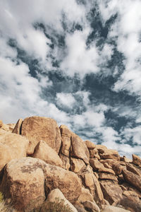 Low angle view of rock formation against sky