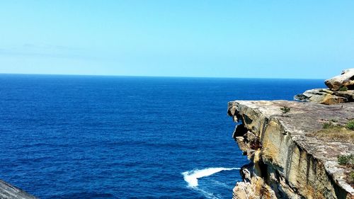 Scenic view of sea against clear blue sky