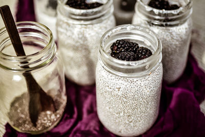 Chia seed almond milk pudding in glass jars topped with fresh raw blackberries