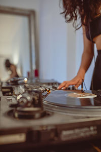 Fashionable young woman playing music at home