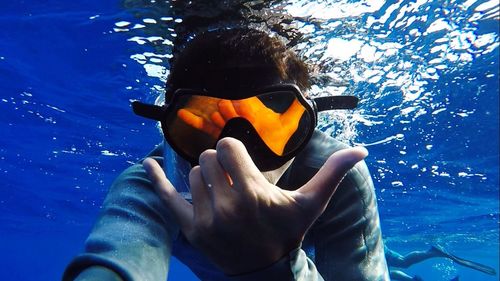 Close-up of young woman swimming in pool