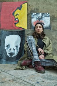 Portrait of a young woman sitting outdoors